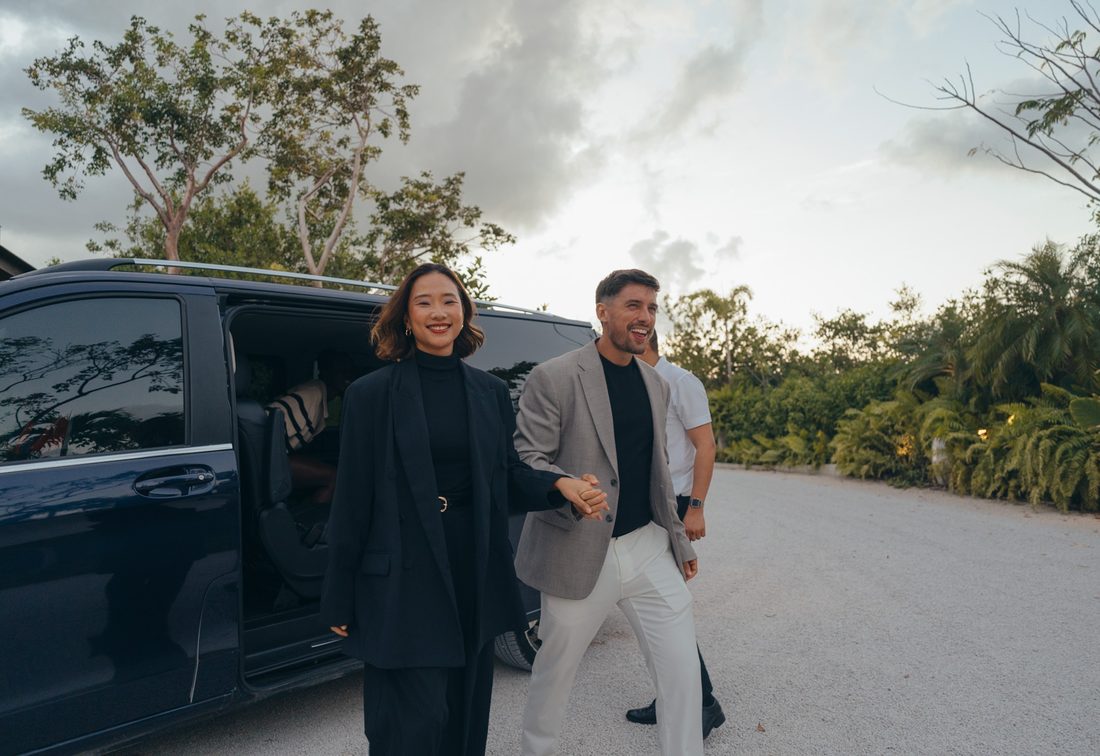Well-dressed travelers arriving at their destination with Ride Luxe